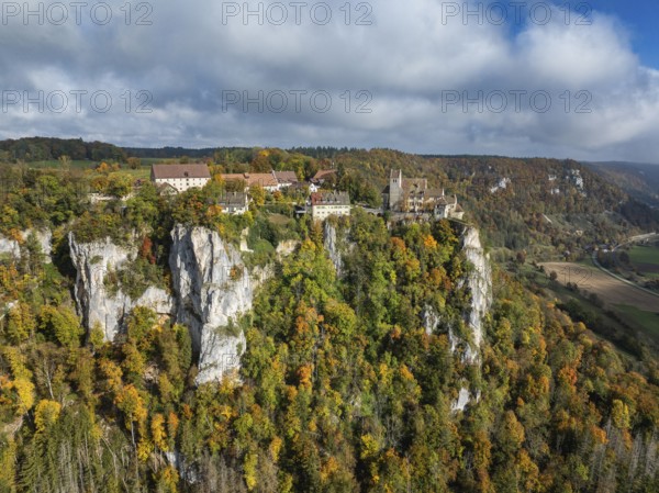 Aerial view of Werenwag Castle and former Werenwag Castle on a rocky spur in the Upper Danube Valley, surrounded by autumnal vegetation and clouds of fog, Sigmaringen district, Baden-Württemberg, Germany