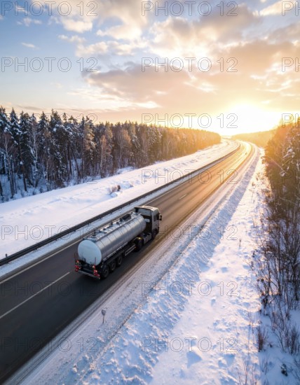 Petrol cargo truck lorry tanker driving on highway hauling oil products at sunrise, wide snowy landscape in winter, AI generated