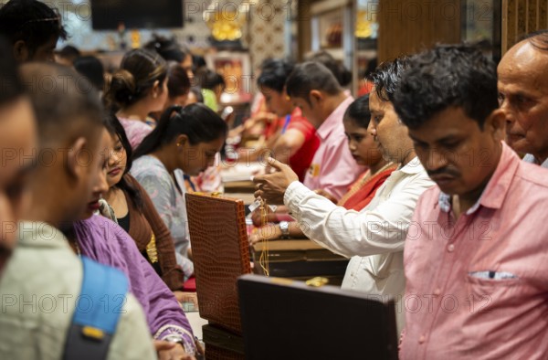 Customers purchase Gold jewelry at a store on the occasion of the festival of Dhanteras, in Guwahati, Assam, India on 18 October 2025. People rushing to buy gold even after its nearly 60% surge to record highs this year