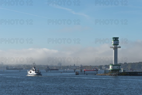 Green-white lighthouse Friedrichsort with city panorama of the state capital, Kiel Fjord, Kiel, haze bell, shipping, tower, architecture, landmark, orientation, navigation, shipping, blue sky, Schleswig-Holstein, Germany