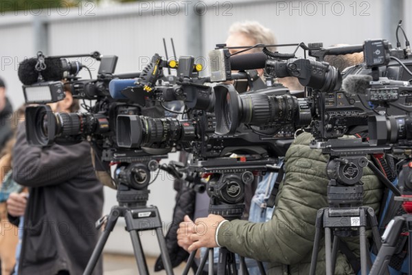 Camera crews, TV teams from various radio stations, television stations, film at a press conference