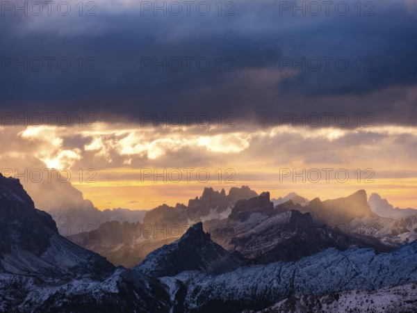 Morning light through dark clouds over the Dolomites, Alps, Belluno province, Veneto region, Veneto, Italy