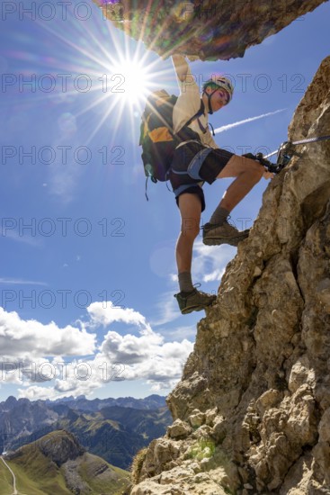 Mountaineer climbs on Ferrata Furcela de Saslonch, Langkofelscharte via ferrata, Dolomites, Trentino, South Tyrol, Italy