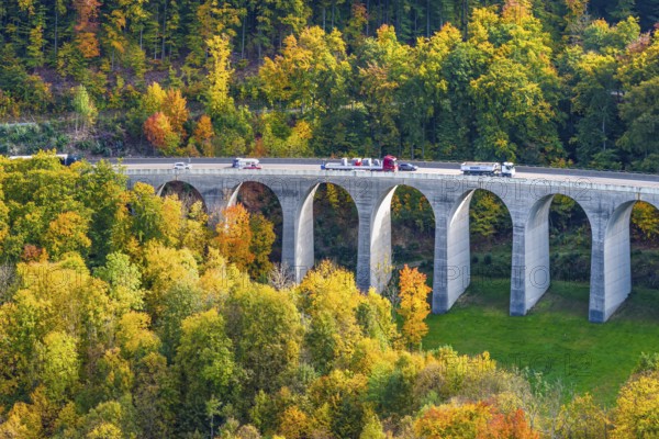 Todsburg bridge on the A8 motorway near Mühlhausen. Alpine climb to the Swabian Jura in autumn. The roadways are separated, the Alben descent takes place over a parallel valley. Drone photo. Mühlhausen im Täle, Baden-Württemberg, Germany