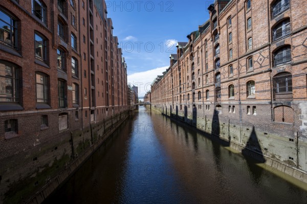Canal between red brick buildings, warehouses in Hamburg's Speicherstadt, Hamburg, Germany