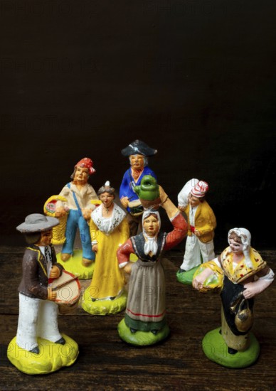 Colorful Provençal terracotta figurines represent traditional characters from rural life. Each figure is uniquely crafted, depicting musicians, farmers, and market sellers in detailed attire