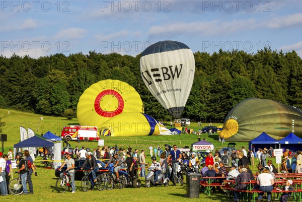 Hot air balloons being prepared for take-off as part of an air show at the Rossfeld in Metzingen-Glems, Baden-Württemberg, Germany, for editorial use only