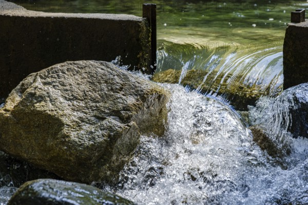 Water flows through an open dam, Horlachbach below the Stuiben Falls near Umhausen in Ötztal, Tyrol, Austria