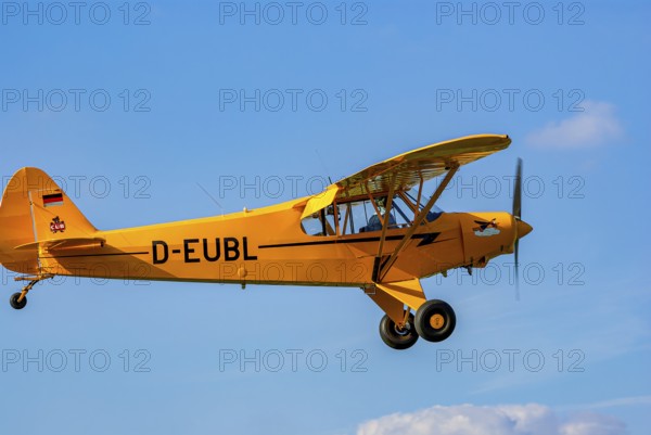 A Piper PA-18 Super Cub of the Bravo Lima Formation during a flight demonstration as part of an air show at the Rossfeld in Metzingen-Glems, Baden-Württemberg, Germany, for editorial use only