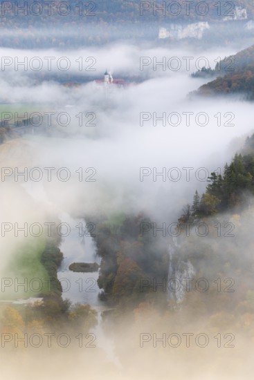 View of Benedictine monastery Beuron, Archabbey of St. Martin, Danube, river, limestone rock, rock face, mixed forest, autumn colours, fog, autumn, Fridingen, Danube valley, Upper Danube nature park Park, Baden-Württemberg, Germany