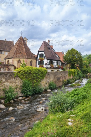 Picturesque Kaysersberg with half-timbered houses on the Weiss river in the old town centre