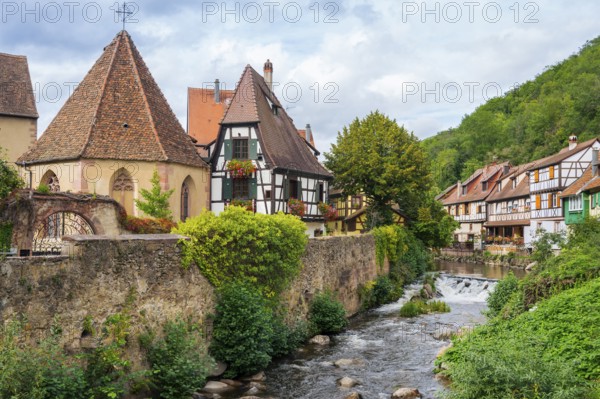 Picturesque Kaysersberg with half-timbered houses on the Weiss river in the old town centre