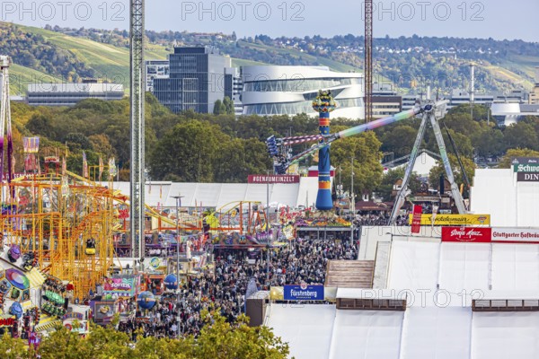 The 178th Cannstatter Volksfest on the Wasen attracted 4.2 million visitors. The Wasenrummel is one of the most important traditional festivals in Germany. In the background is the headquarters of Mercedes-Benz Group AG. Bad Cannstatt, Stuttgart, Baden-Württemberg, Germany