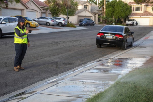Las Vegas, Nevada - Devyn Choltko, a water waste investigator, patrols a residential neighborhood, recording and issuing tickets for illegal water use. The Las Vegas Valley Water District has cut usage of scarce Colorado River water by more than 30% over the last 20 years despite a growing population