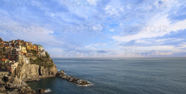 Manarola panorama with colorful buildings overlooking scenic shoreline. Cinque Terre landscapes in Italy in Amalfi Coast