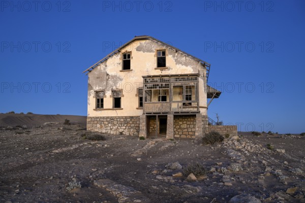Dilapidated building in the desert sand, blue hour, Kolmanskop, near Lüderitz, Karas region, Namibia