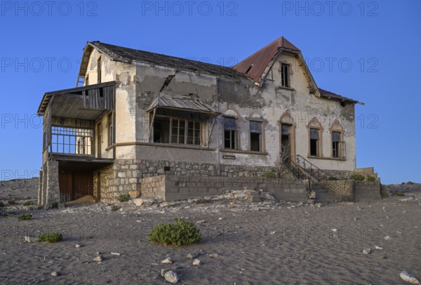 Dilapidated accountant's house in the desert sand, blue hour, Kolmanskop, near Lüderitz, Karas Region, Namibia