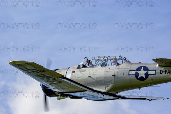 A North American AT-6D with the registration D-FAML during a flight demonstration as part of an air show at the Rossfeld in Metzingen-Glems, Baden-Württemberg, Germany, for editorial use only