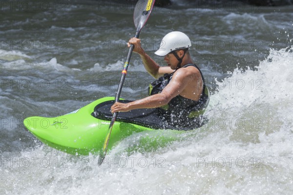Young man kayaking in river, Costa Rica, Central America