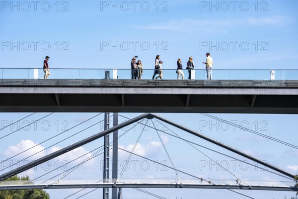 Bridges in Düsseldorf, in the foreground, the pedestrian and cycle bridge over the canal to the inner harbour, media harbour of Düsseldorf, behind it the Rheinkniebrücke, road bridge over the Rhine near Düsseldorf, Germany
