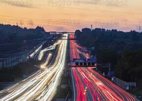 Motorway near Stuttgart with several lanes in the evening with sunset. Heavy traffic with light lanes. BAB 8 motorway near Wendlingen, Baden-Württemberg, Germany