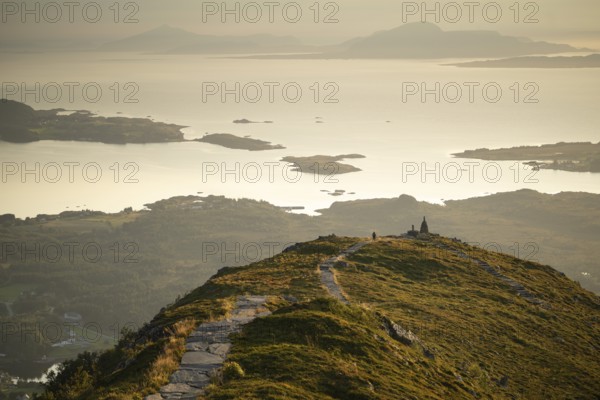 Cairns and view over islands and sea, evening mood, Rørsethornet stone staircase, with 3292 steps one of the longest continuous stone staircases in the world, Sherpat staircase or Midsund staircase or Midsundtrappene, Rørsethornet hike, Otroya or Otrøya island, Møre og Romsdal, Norway