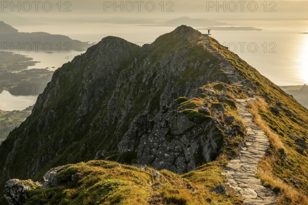 Hikers on the Rørsethornet stone staircase, with 3292 steps one of the longest continuous stone staircases in the world, Sherpatreppe or Midsundtreppe or Midsundtrappene, Rørsethornet hike, evening mood, Otroya or Otrøya island, Møre og Romsdal, Norway
