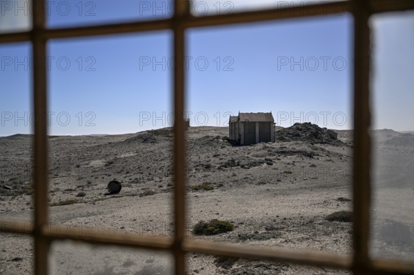 View from a dilapidated building into the desert, Pomona, restricted diamond area, near Lüderitz, Karas region, Namibia