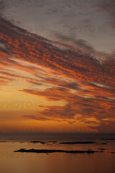 Offshore islands and skerries, sea, dramatically illuminated clouds, sunset, Otroya or Otrøya island, Møre og Romsdal, Norway