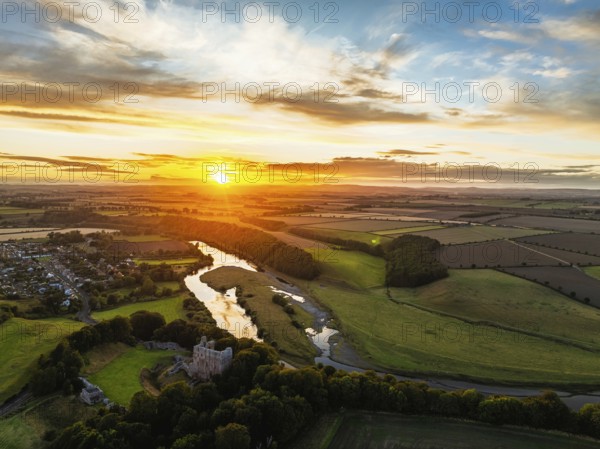 Sunset over Norham Castle and River Tweed from a drone, Norham, Northumberland, England, United Kingdom