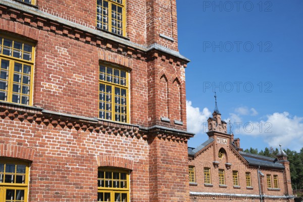 Brick façade with yellow windows, former paper factory and mill for the production of groundwood pulp board, UNESCO World Heritage Site Factory Village Verla, Maailmanperintökohde Verlan puuhiomo ja pahvitehdas, Verla Rapids, Kymenlaakso, near Kouvola, Finland