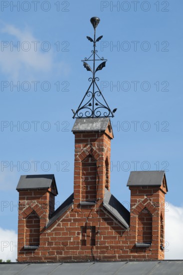 Iron ornamental element on roof peak, brick gable, former paper mill for the production of groundwood pulp board, UNESCO World Heritage Site Factory Village Verla, Maailmanperintökohde Verlan puuhiomo ja pahvitehdas, Verla Rapids, Kymenlaakso, near Kouvola, Finland