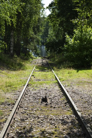 Railway line leads to Lake Väha Kamponen, former paper mill for the production of groundwood pulp board, UNESCO World Heritage Site Verla Factory Village, Maailmanperintökohde Verlan puuhiomo ja pahvitehdas, Verla Rapids, Kymenlaakso, near Kouvola, Finland