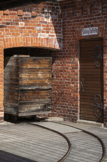 Old wooden trolley on rails, brick wall, former paper mill for the production of groundwood pulp board, UNESCO World Heritage Site Verla Factory Village, Maailmanperintökohde Verlan puuhiomo ja pahvitehdas, Verla Rapids, Kymenlaakso, near Kouvola, Finland