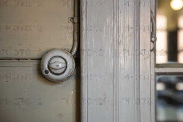 Old light switch on wooden wall, former paper factory and mill for the production of groundwood pulp board, UNESCO World Heritage Site Verla Factory Village, Maailmanperintökohde Verlan puuhiomo ja pahvitehdas, Verla Rapids, Kymenlaakso, near Kouvola, Finland