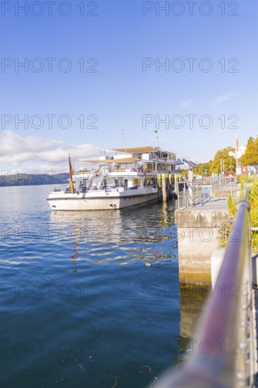 Ship in the harbour under a clear sky on calm water, Überlingen, Lake Constance, Germany