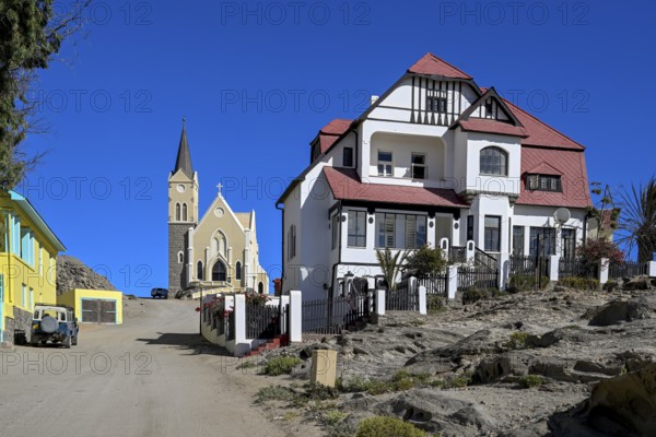 Colonial house facade in the Kirchstraße, in the background the rock church, Lüderitz, Karas region, Namibia
