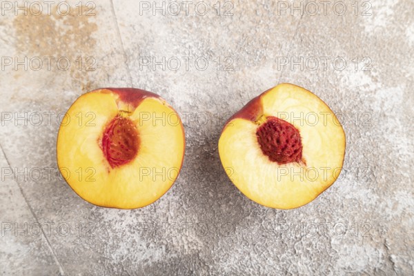 Peach Cut in half on brown concrete background. Top view, flat lay, close up. healthy food, vegetable, minimalism