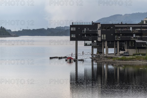 Modern residential building on the shore of Lake Mjosa with a jetty, Eidsvoll, Akershus, Norway