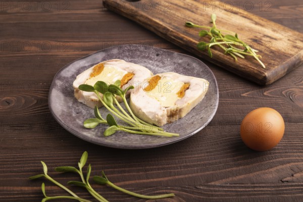 Chicken, egg and dried apricot meatloaf, microgreen on brown wooden. Diet, healthy eating. side view, close up