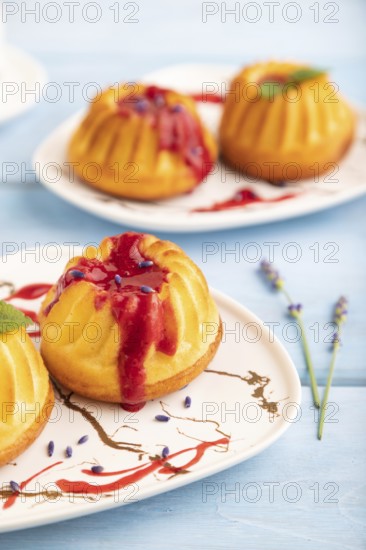 Semolina cheesecake with strawberry jam, lavender, cup of coffee on blue wooden background. side view, close up, selective focus
