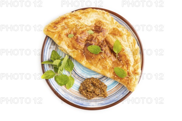 Fried homemade Khachapuri cake with cheese and meat, fried in pan. Traditional Georgian cuisine isolated on white background. Top view, flat lay, close up