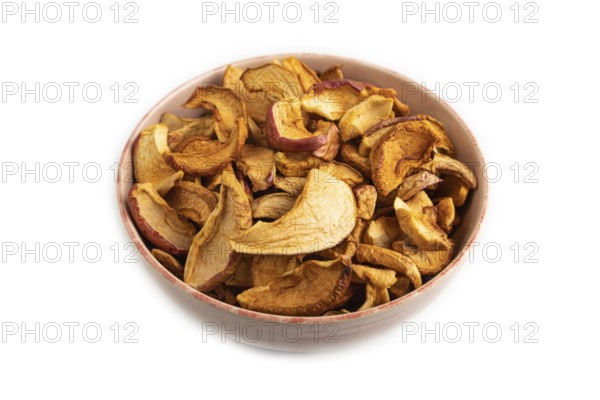 Dried Apples in ceramic bowl isolated on white background. Side view, close up. healthy food, minimalism. sweet