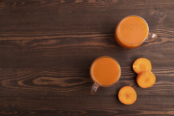 Two glasses with carrot juice, on wooden background. Diet, healthy eating concept. top view, flat lay, copy space, minimalism