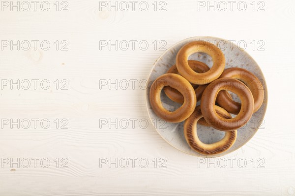 Homemade Ring Bagel on white wooden background. top view, flat lay, copy space