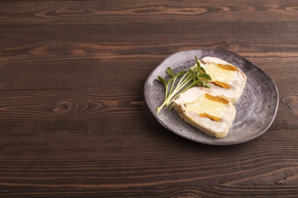 Chicken, egg and dried apricot meatloaf, microgreen on brown wooden. Diet, healthy eating. side view, copy space