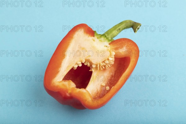 Red Cutted pepper on blue pastel background. Side view, copy space. Tropical, healthy food, vegetable, slice, minimalism