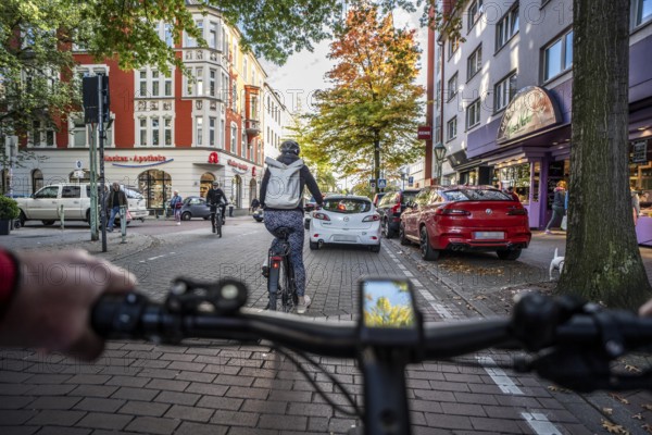 Cycling in the city, city centre road, cycle lane, two-wheeled traffic has priority, 30 km/h zone, cyclists' perspective, Essen, North Rhine-Westphalia, Germany
