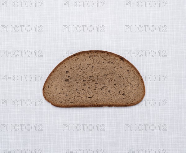 Top shot of a slice of bread on a white Resopal plate
