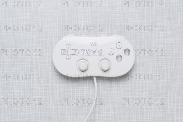 Top shot of a Wii Classic controller on a white Formica plate